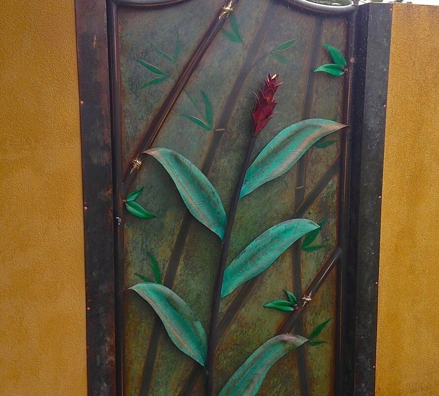 Decorative wall panel featuring a green leaf design on a brown background.