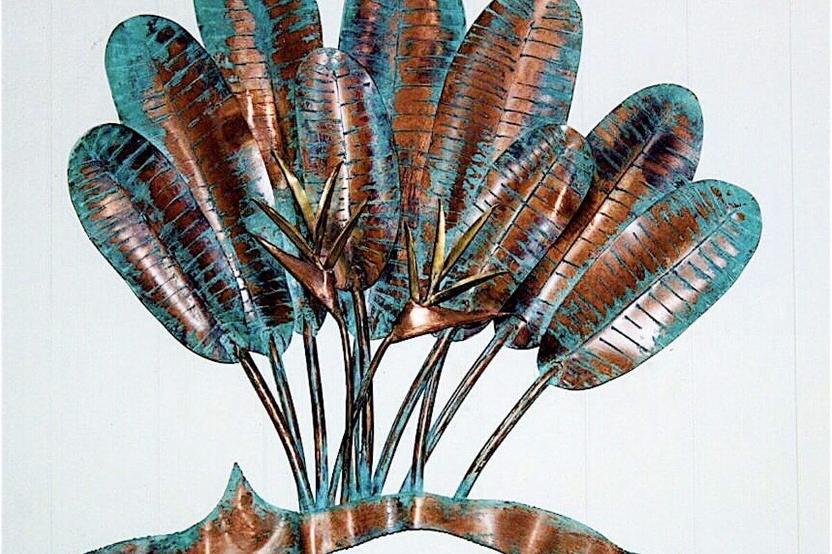 Decorative peacock feather fan sculpture with vibrant colors.