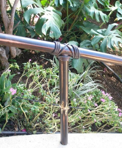 Close-up of a decorative iron railing with a tied knot design.