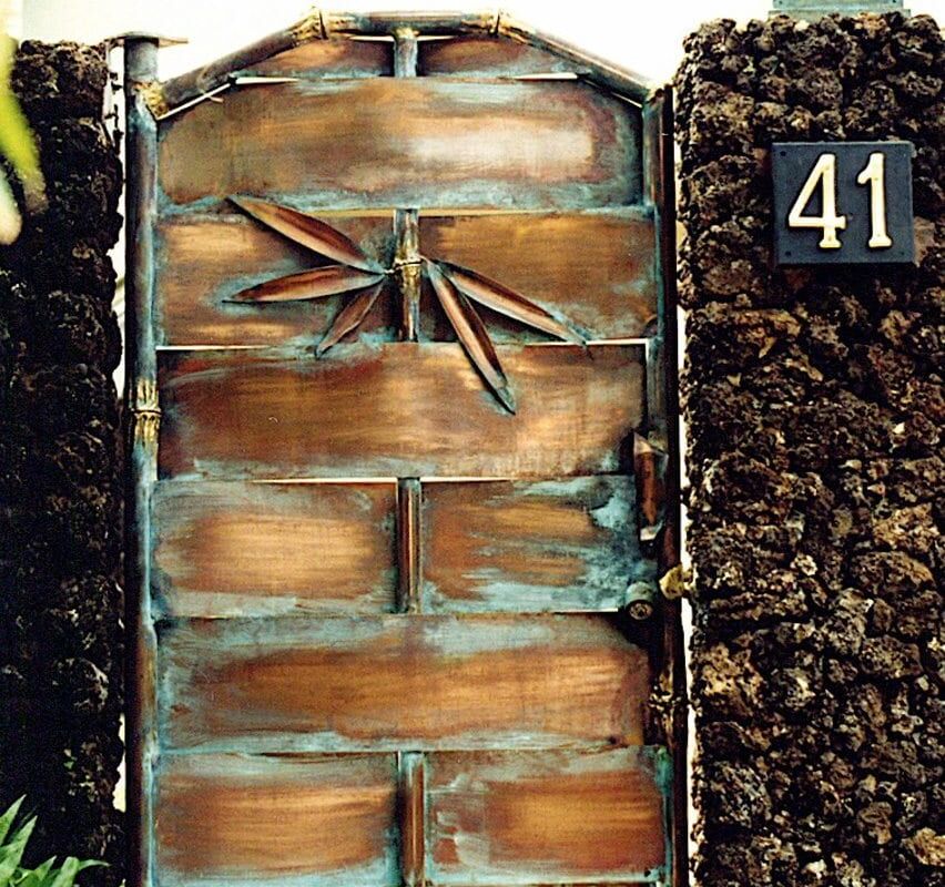 Rustic wooden door with a metal latch and house number 41 on a stone wall.