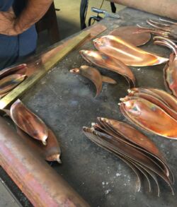 Cut and formed bamboo leaves in a variety of sizes Fresh squid displayed on a market stall for sale.
