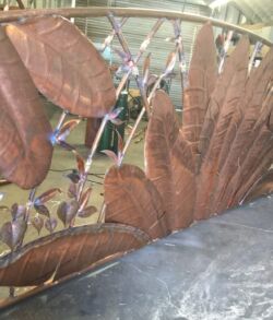The main entry gate with the texture of the leaves with all natural copper colors Copper or bronze metal sculpture with leaves and branches design.