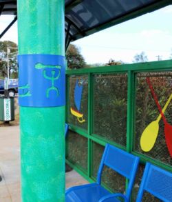 Colorful playground seating area with paddles and nets.