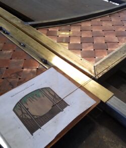 A wooden board game with a checkerboard pattern and a book with an illustration.