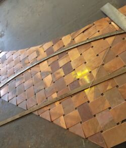 Woven wooden strips forming a checkered pattern on a flat surface.
