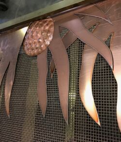 Copper art piece featuring flame-like shapes.