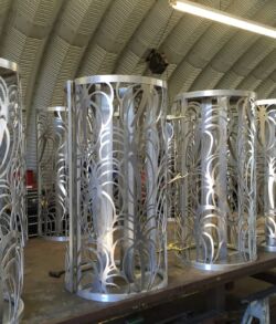 Intricately designed metal columns displayed indoors.