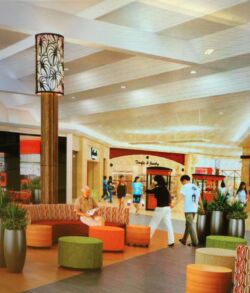 Modern indoor lounge area with colorful seating and people.