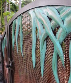 Detail close up of Hala leaves and fruit Close-up of a textured sculpture with blue-green drips and a pinecone-like pattern.