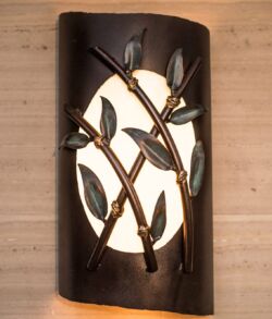 Decorative copper bamboo wall sconce using bronze patina with a hint of green for the bamboo leaves. Wall sconce with a nature-inspired metal branch design and soft white light.