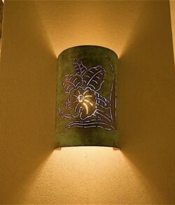 Decorative back lit floral wall sconce Decorative wall sconce casting light and shadows.