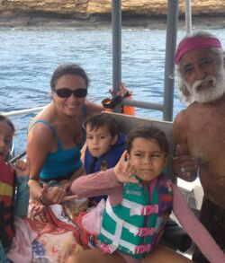 Family enjoying a boat ride on a sunny day.
