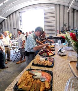 Attendees enjoying lunch provided by Padilla Designs in the studio People enjoying a buffet-style meal in a rustic setting.