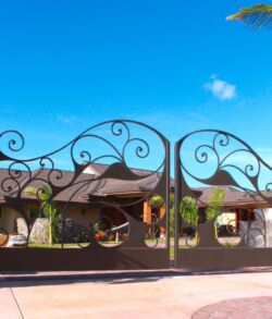 Ornate wrought iron gate under a clear blue sky.