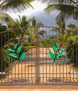 A gated entrance with lush tropical plants and a distant view of the ocean.