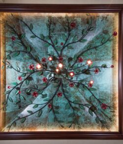 Decorative ceiling light fixture with branches and glowing bulbs.