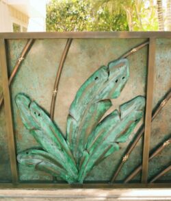 Custom copper and brass banana leaf and bamboo entrance gate offering complete privacy Decorative metal panel with green patina leaves design.
