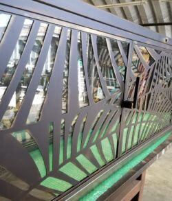 Decorative metal railing with geometric cut-out patterns.