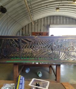 Intricately carved wooden panel depicting tropical foliage and birds.