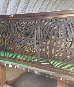 Intricately carved wooden headboard with a leaf pattern design.