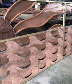Stacked clay roof tiles drying in a workshop.