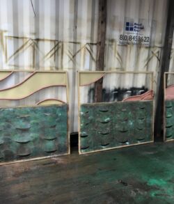 A warehouse with stacked green crates and industrial shelving.