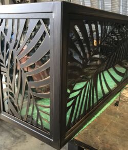 Decorative metal corner panel with palm leaf design.