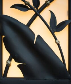 Close-up of a black metal sculpture with leaves and stems.