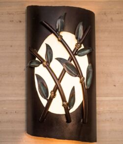 Decorative wall sconce with bamboo design and warm light.