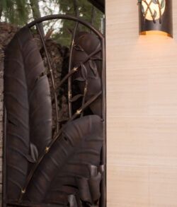 Decorative large dark leaves panel with modern wall light.