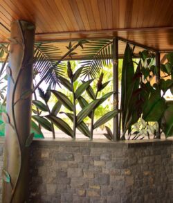 Decorative tropical-themed wall art with lush green leaves.