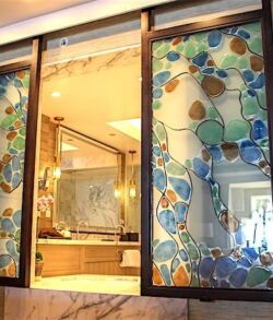 Decorative stained glass door featuring floral and leaf patterns.