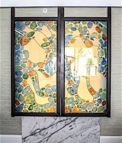 Stained glass window with colorful floral and geometric patterns.