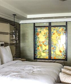 Cozy bedroom with a large bed and floral window art.