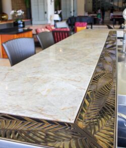 Long marble tabletop with patterned base in a showroom.