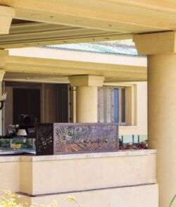 Outdoor seating area with a stone table and beige columns.