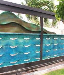 Back side view. Decorative glass panel with wave patterns in an outdoor setting.