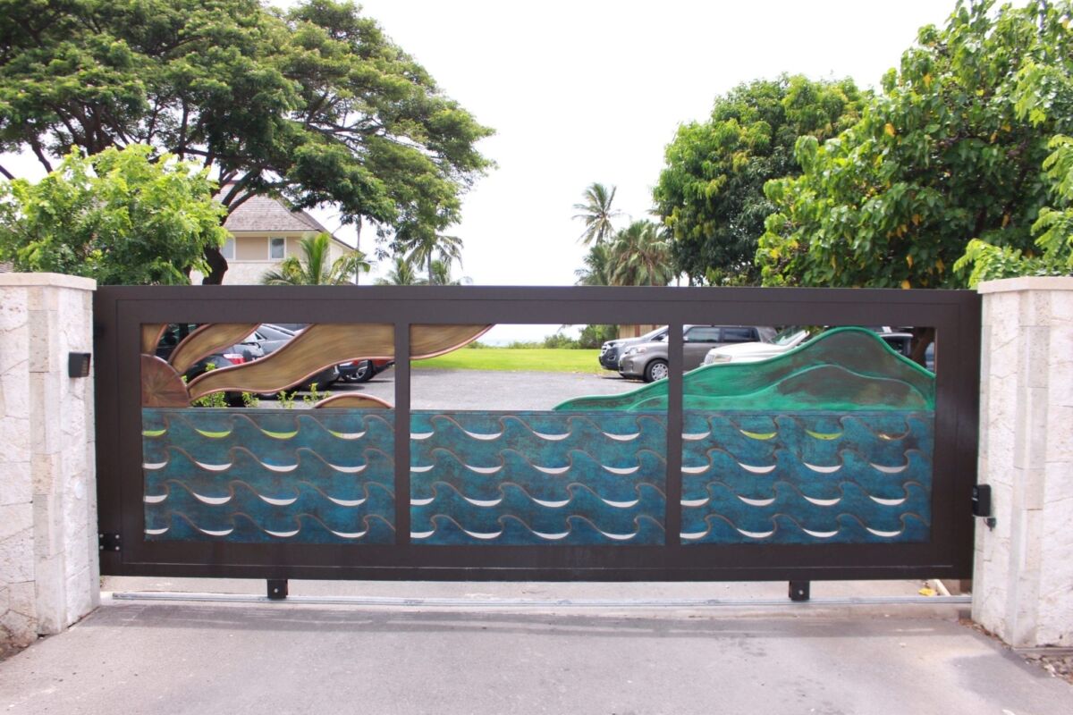 Colorful wave-patterned glass panels on a balcony railing with trees in the background.
