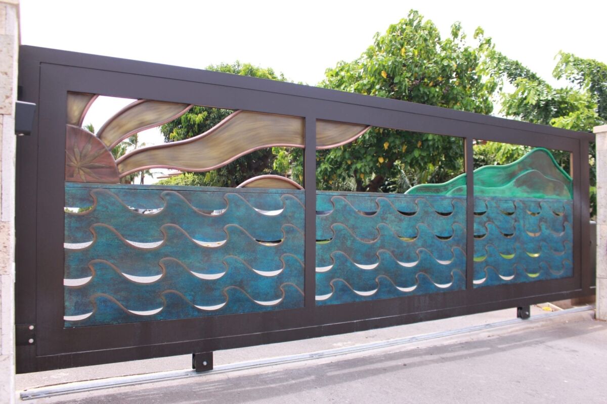 Decorative glass fence with wave patterns outside a property.