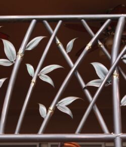 Close up of bamboo details Decorative metal railing with leaf patterns and geometric lines.