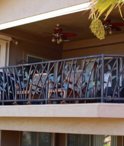Close up full view Cozy balcony with black railing and ceiling fan in a residential building.
