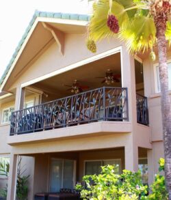 After, Full side view Two-story house with a balcony and tropical plants.