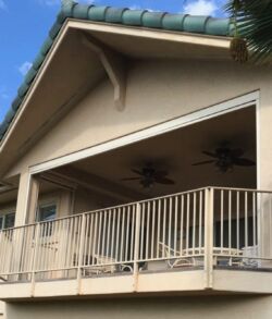 Before pictures Balcony with ceiling fans on a sunny day under a blue sky.