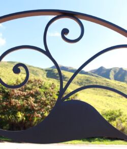 Decorative wrought iron railing framing a scenic mountain view.