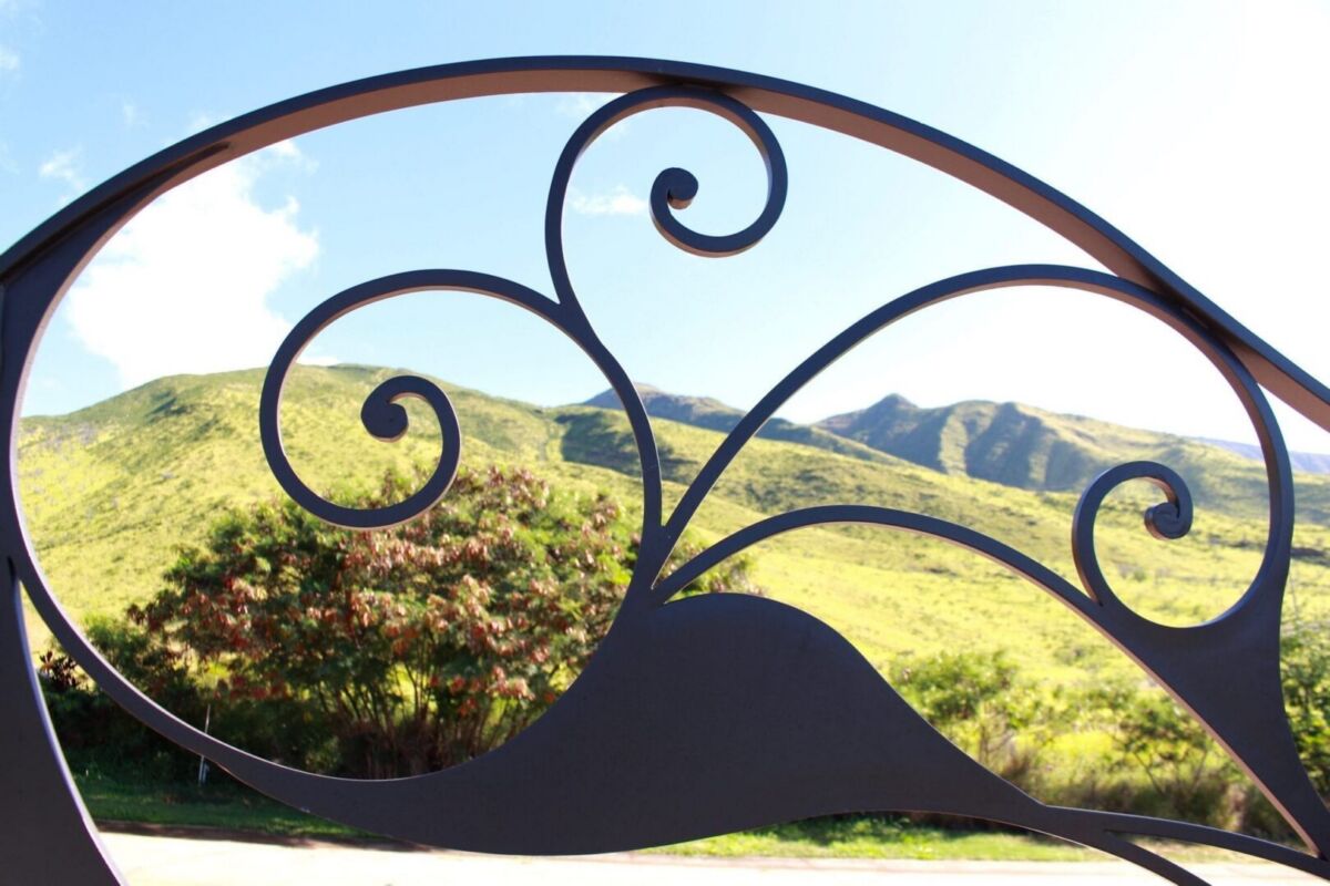 Decorative wrought iron railing framing a scenic mountain view.