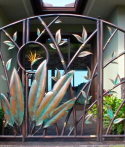 Framed view of Man gate. Decorative metal gate featuring bamboo design and a sun motif.
