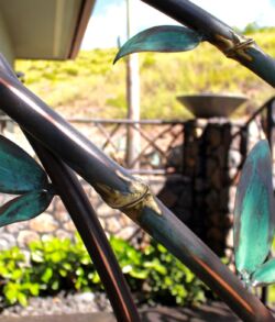 Detailed close up shot of panel. Close-up of metal branches with green leaves in a garden.