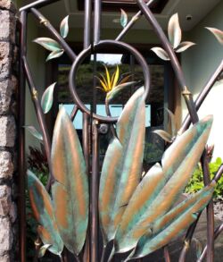 Detailed close up shot. Decorative metal angel wings with a yellow flower in the background.
