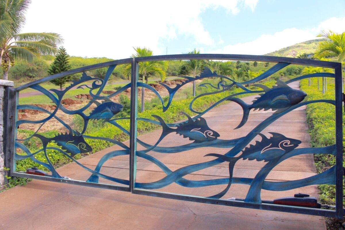 Decorative metal gate with intricate, nature-inspired designs.