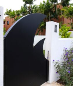 Modern black and white gate with curved design.
